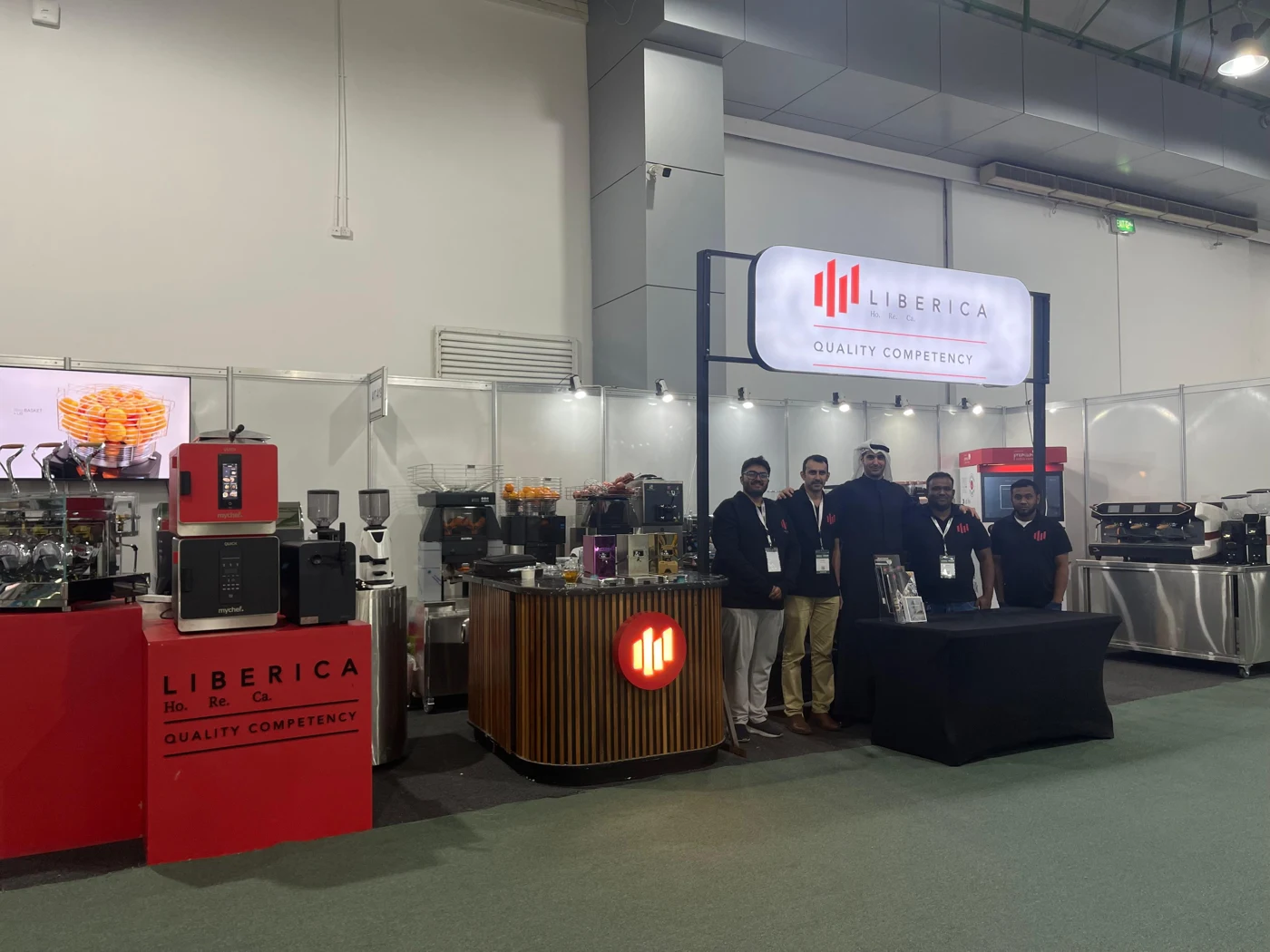Liberica Horeca team at an exhibition stand displaying professional coffee and beverage equipment